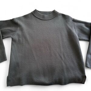 Dark gray mock neck sweater.